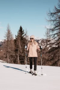 Winter fun for little explorers - young girls snowshoeing in the snow-covered mountains around Hofgut Wagrain, surrounded by sun, snow and nature.