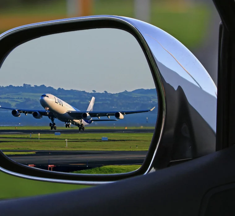 Aeroplane taking off - captured in the rear-view mirror, a symbol of departure, wanderlust and new perspectives.