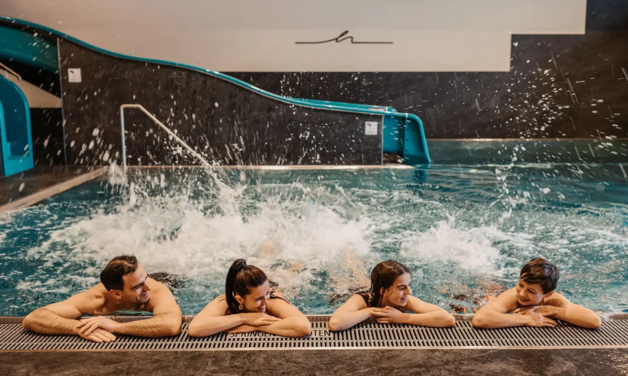 Unbeschwerter Badespaß für die ganze Familie: Im warmen Indoorpool des Hofgut Wagrain genießen Groß und Klein ausgelassene Momente – mit Wasserrutsche, Spritzvergnügen und ganz viel Lachen.