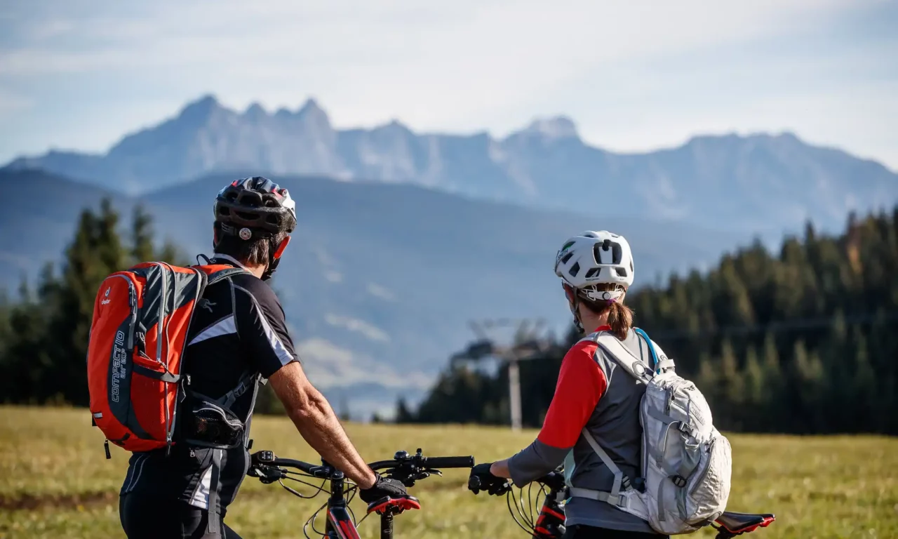 Bike&Relax Package Two cyclists enjoy the view of the mountain panorama while biking around Hofgut Wagrain