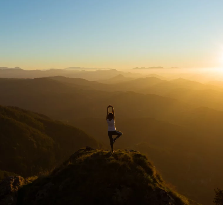 Yoga at sunrise - a mindful moment of peace and inner balance high above the mountains of Salzburger Land.