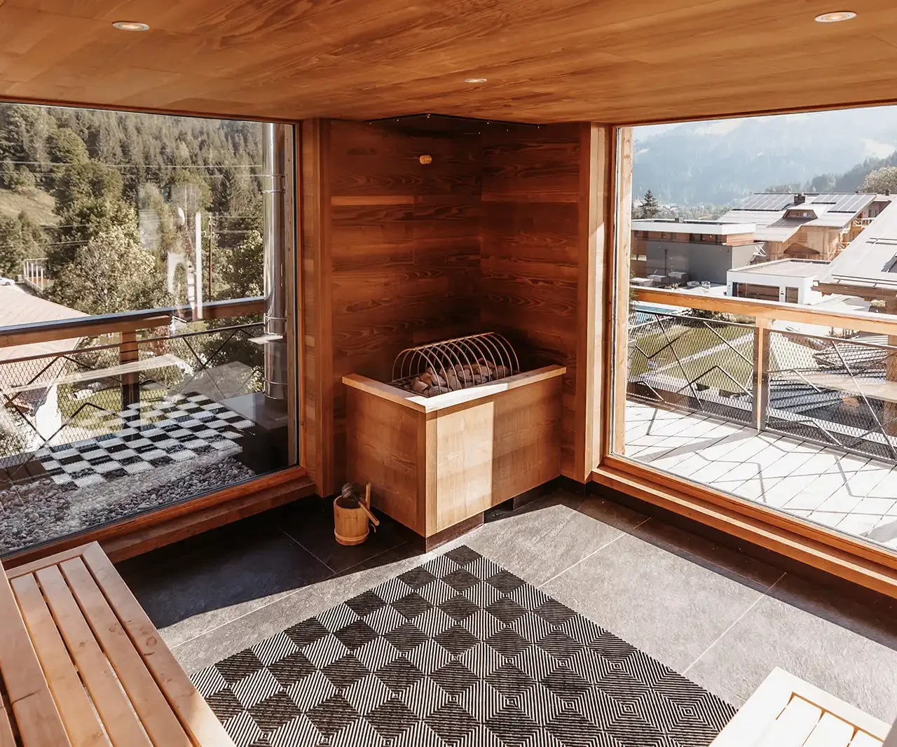 Hofgut©Elisabeth_Fotografie-614 Modern sauna with large windows and views of the surrounding mountain landscape.