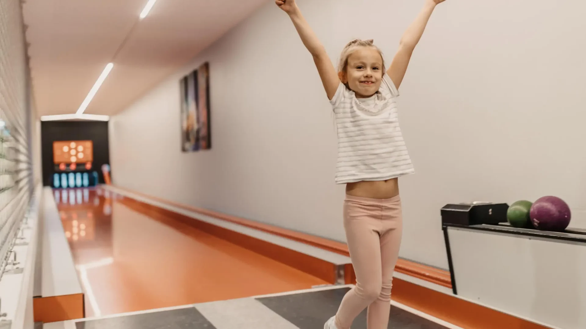 Strahlender Kegelerfolg: Glücksmomente für Kinder auf der hauseigenen Kegelbahn im Hofgut Wagrain – Spiel & Spaß für die ganze Familie.